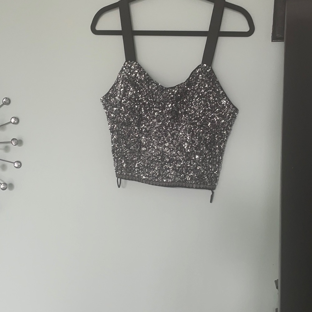 This a black sequins top that zips on the side